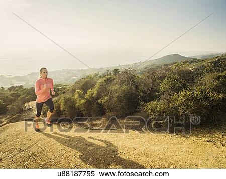Stock Photography - Woman running in mountains. Fotosearch
