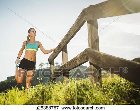 Woman stretching outdoors View Large Photo Image Stock Photo - Woman stretching outdoors. Fotosearch