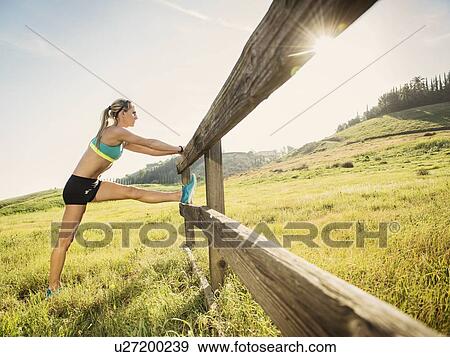 Stock Photo - Woman stretching outdoors. Fotosearch