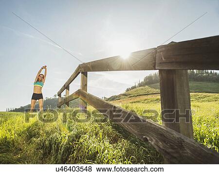 Stock Photo - Woman stretching outdoors. Fotosearch
