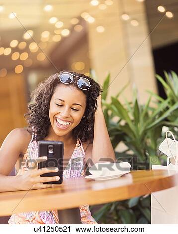Woman using phone in cafe View Large Photo Image Stock Image - Woman using phone in cafe. Fotosearch