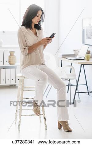 Stock Image - Woman using smart phone. Fotosearch