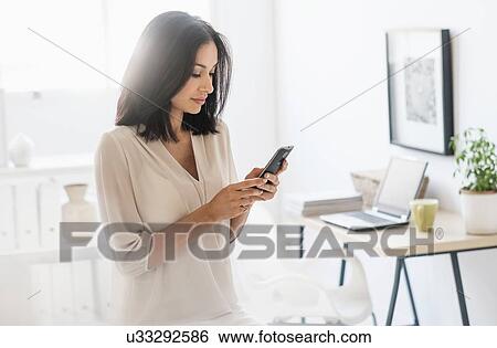Woman using smart phone View Large Photo Image Stock Photograph - Woman using smart phone. Fotosearch