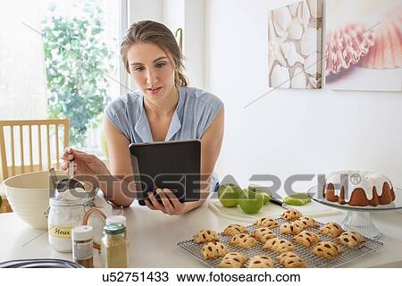 Young woman baking in kitchen View Large Photo Image Stock Image - Young woman baking in kitchen. Fotosearch