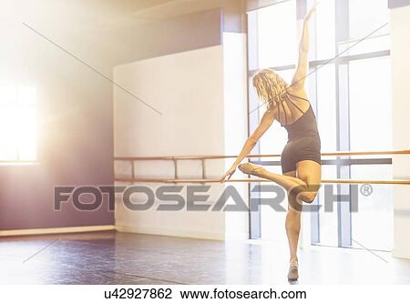 Young woman dancing in dance studio View Large Photo Image Stock Image - Young woman dancing in dance studio. Fotosearch