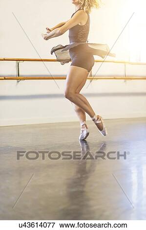 Stock Photo - Young woman dancing in dance studio. Fotosearch