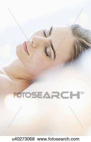 Stock Photo - Young woman during beauty treatment. Fotosearch