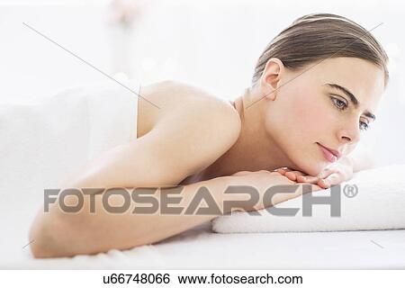 Stock Photograph - Young woman relaxing in spa. Fotosearch