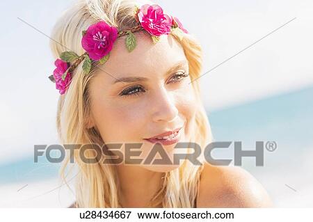 Stock Photo - Young woman smiling on beach. Fotosearch