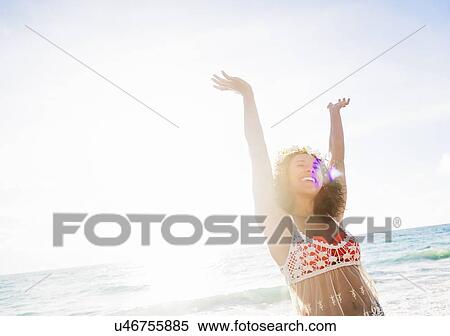 Young woman smiling on beach View Large Photo Image Stock Photography - Young woman smiling on beach. Fotosearch