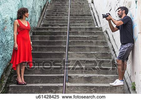 Behind the scenes of an urban fashion shoot with female model and male photographer View Large Photo Image Stock Photography - Behind the scenes of an urban fashion shoot with female model and male photographer. Fotosearch