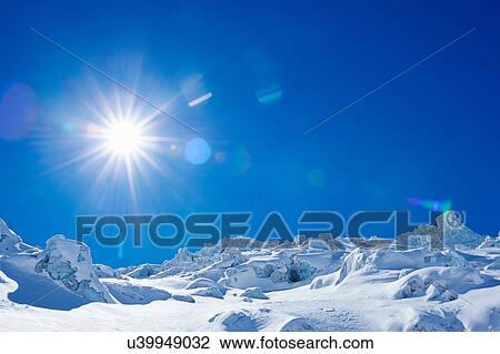 Stock Image - Bizarre snow covered landscape and blue sky, Mont Blanc massif, Graian Alps, France. Fotosearch