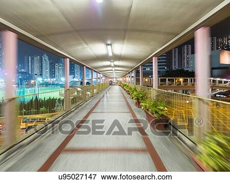 Blurred motion view of elevated walkway at night, Hong Kong, China View Large Photo Image Stock Photo - Blurred motion view of elevated walkway at night, Hong Kong, China. Fotosearch