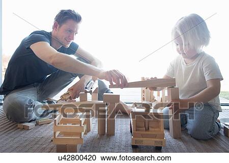 Boy carrying basket of wooden blocks View Large Photo Image Stock Image - Boy carrying basket of wooden blocks. Fotosearch