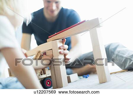 Stock Photo - Boy carrying basket of wooden blocks. Fotosearch