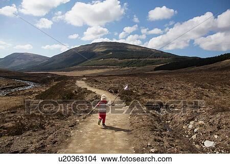 Picture - Boy on path with flag, Fairy Pools, Isle of Skye, Hebrides, Scotland. Fotosearch