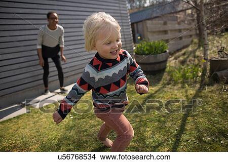Boy running in garden, smiling View Large Photo Image Picture - Boy running in garden, smiling. Fotosearch