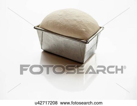 Stock Photo - Bread dough prepared in loaf tin. Fotosearch