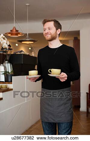 Cafe waiter serving cups of fresh coffee View Large Photo Image Stock Image - Cafe waiter serving cups of fresh coffee. Fotosearch