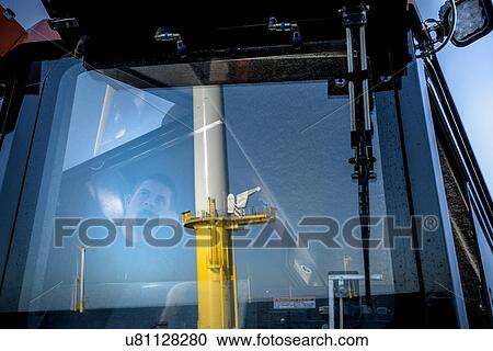 Captain of boat speaking on radio in bridge on offshore wind farm View Large Photo Image Stock Image - Captain of boat speaking on radio in bridge on offshore wind farm. Fotosearch