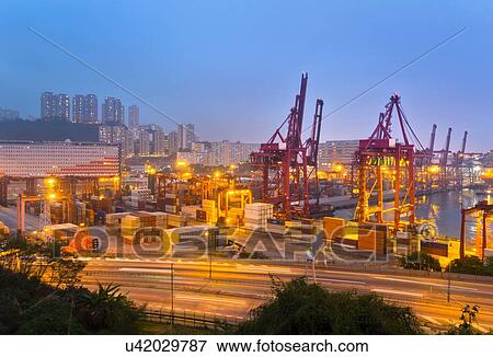 Cargo containers and loading cranes illuminated at night, Hong Kong, China View Large Photo Image Stock Photo - Cargo containers and loading cranes illuminated at night, Hong Kong, China. Fotosearch