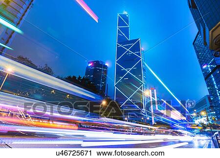 Stock Image - Central Hong Kong business district: skyline with Bank of China building and light trails at dusk, Hong Kong, China. Fotosearch