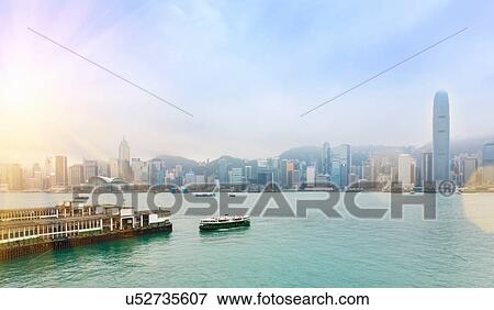 Stock Photo - Central Hong Kong skyline and Star Ferry crossing Victoria harbor, Hong Kong, China. Fotosearch