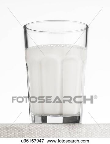 Stock Photo - Close up of drinking glass of frothy effervescent water. Fotosearch