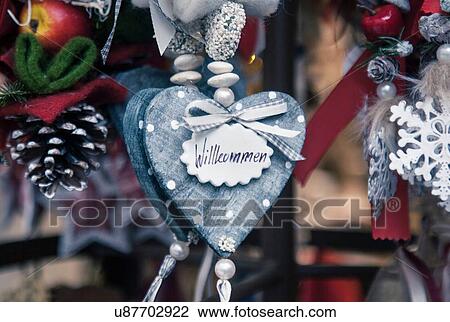 Stock Image - Close up of heart shaped xmas decorations on German Christmas market stall. Fotosearch