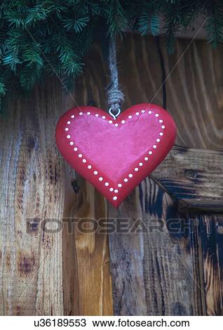 Stock Image - Close up of pink heart shaped xmas decoration on German Christmas market stall. Fotosearch