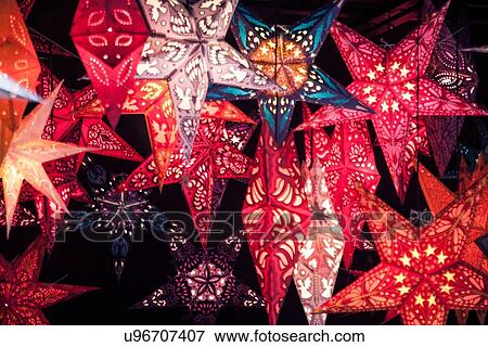 Close up of star shaped lantern xmas decorations on German Christmas market stall View Large Photo Image Stock Photo - Close up of star shaped lantern xmas decorations on German Christmas market stall. Fotosearch