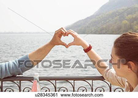 Couple making heart shape with hands, Lake Mergozzo, Verbania, Piemonte, Italy View Large Photo Image Stock Image - Couple making heart shape with hands, Lake Mergozzo, Verbania, Piemonte, Italy. Fotosearch