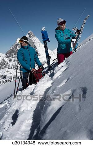 Stock Photography - Couple with skis on mountain, Zermatt, Valais, Switzerland. Fotosearch