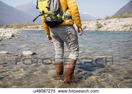 Cropped rear view of young male hiker crossing Toce river, Vogogna, Verbania, Piemonte, Italy View Large Photo Image Stock Photography - Cropped rear view of young male hiker crossing Toce river, Vogogna, Verbania, Piemonte, Italy. Fotosearch