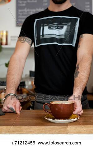 Cropped shot of cafe waiter serving cup of fresh coffee View Large Photo Image Stock Photograph - Cropped shot of cafe waiter serving cup of fresh coffee. Fotosearch