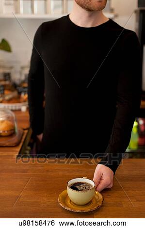 Cropped shot of cafe waiter serving fresh coffee View Large Photo Image Stock Photograph - Cropped shot of cafe waiter serving fresh coffee. Fotosearch