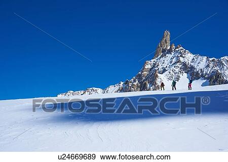 Distant view of three skiers moving up Mont Blanc massif, Graian Alps, France View Large Photo Image Stock Photo - Distant view of three skiers moving up Mont Blanc massif, Graian Alps, France. Fotosearch