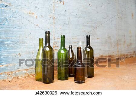 Empty bottles for recycling in front of wall View Large Photo Image Stock Photograph - Empty bottles for recycling in front of wall. Fotosearch