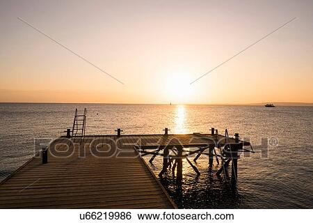 Empty jetty, sunset, Hurgada, Red Sea, Egypt View Large Photo Image Stock Photograph - Empty jetty, sunset, Hurgada, Red Sea, Egypt. Fotosearch