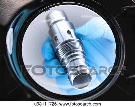 Engineer inspecting machine part under magnifying glass, close up View Large Photo Image Stock Photograph - Engineer inspecting machine part under magnifying glass, close up. Fotosearch