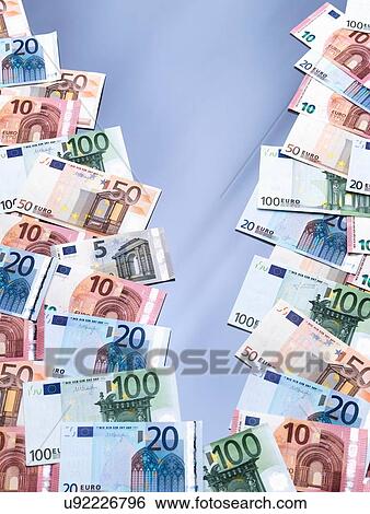 Stock Photograph - Euro currency notes split into two piles. Fotosearch