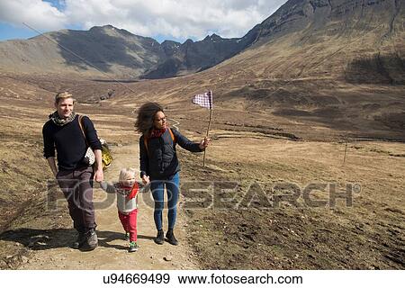 Stock Photo - Family hiking in mountains, Fairy Pools, Isle of Skye, Hebrides, Scotland. Fotosearch