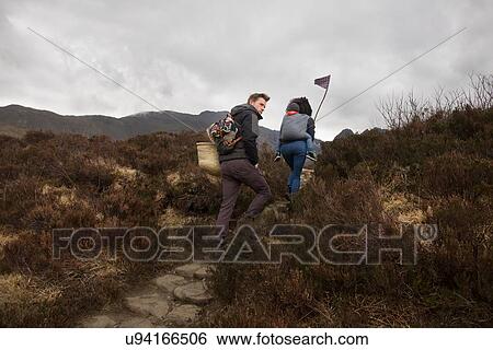 Stock Photograph - Family hiking on path, Fairy Pools, near Glenbrittle, Isle of Skye, Hebrides, Scotland. Fotosearch