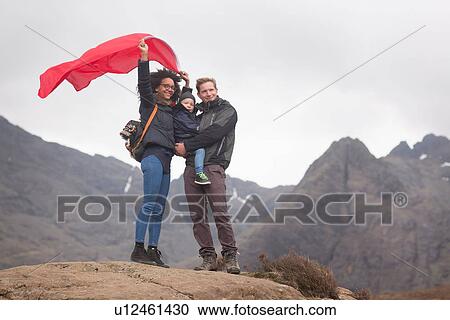 Family holding red flag in mountains, Fairy Pools, Isle of Skye, Hebrides, Scotland View Large Photo Image Stock Image - Family holding red flag in mountains, Fairy Pools, Isle of Skye, Hebrides, Scotland. Fotosearch