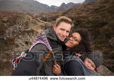 Stock Photograph - Family on hike, smiling towards camera. Fotosearch