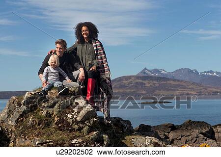 Stock Image - Family on rocks, Loch Eishort, Isle of Skye, Scotland. Fotosearch