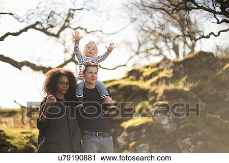 Family on walk, father carrying son on shoulders View Large Photo Image Stock Image - Family on walk, father carrying son on shoulders. Fotosearch