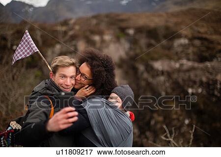 Stock Photo - Family photographing themselves on hike. Fotosearch