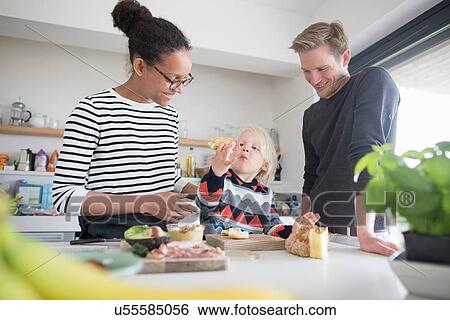 Family preparing food in kitchen View Large Photo Image Stock Photograph - Family preparing food in kitchen. Fotosearch