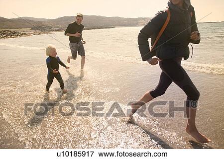 Family running on beach, Loch Eishort, Isle of Skye, Hebrides, Scotland View Large Photo Image Stock Photo - Family running on beach, Loch Eishort, Isle of Skye, Hebrides, Scotland. Fotosearch